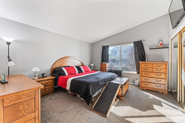 carpeted bedroom featuring lofted ceiling and a textured ceiling