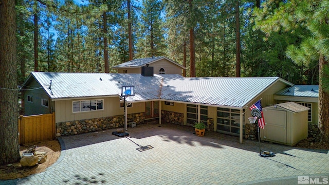 view of front of house with a storage unit