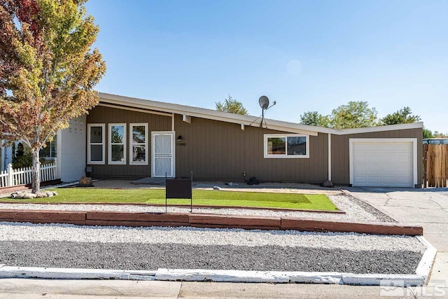 ranch-style house featuring a front yard and a garage