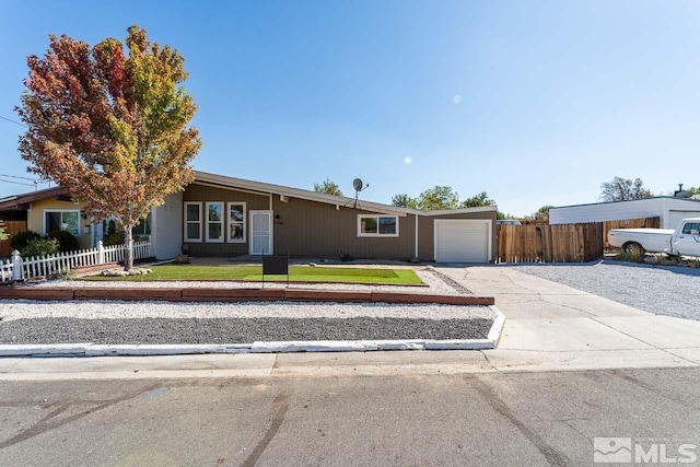 ranch-style home featuring a garage and a front yard