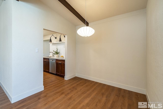 unfurnished dining area with vaulted ceiling with beams and dark hardwood / wood-style flooring