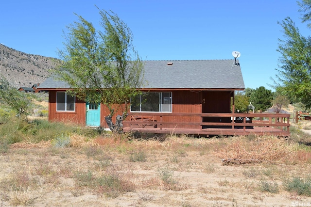 back of house featuring a deck