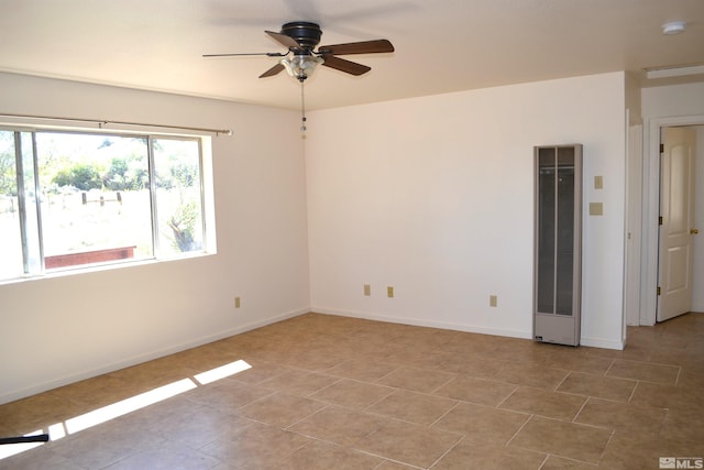 spare room featuring light tile patterned flooring and ceiling fan