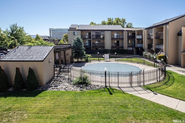 view of pool with a lawn