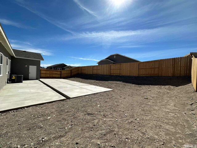 view of yard featuring cooling unit and a patio