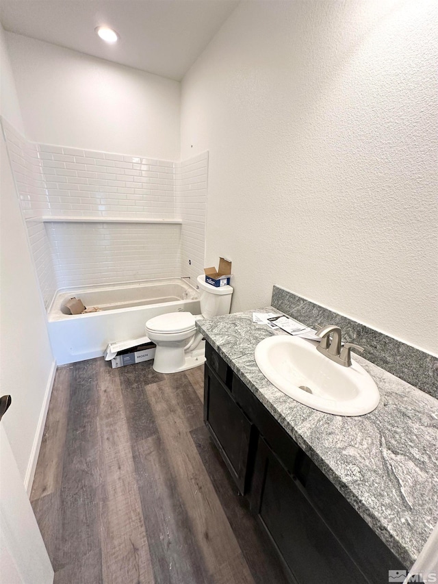 bathroom with hardwood / wood-style floors, vanity, and toilet