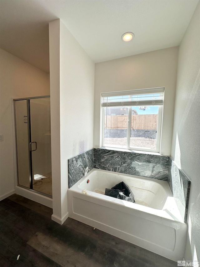 bathroom with wood-type flooring and plus walk in shower