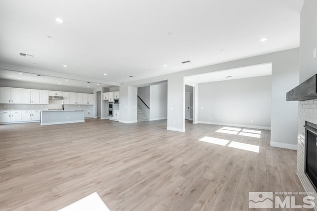 unfurnished living room featuring light wood-type flooring