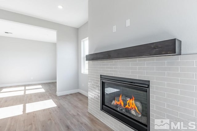 interior details with hardwood / wood-style floors and a fireplace