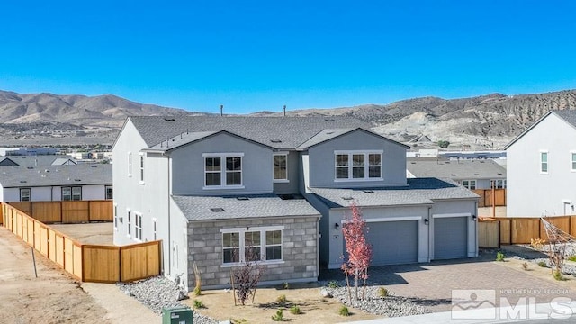 view of front facade with a mountain view and a garage