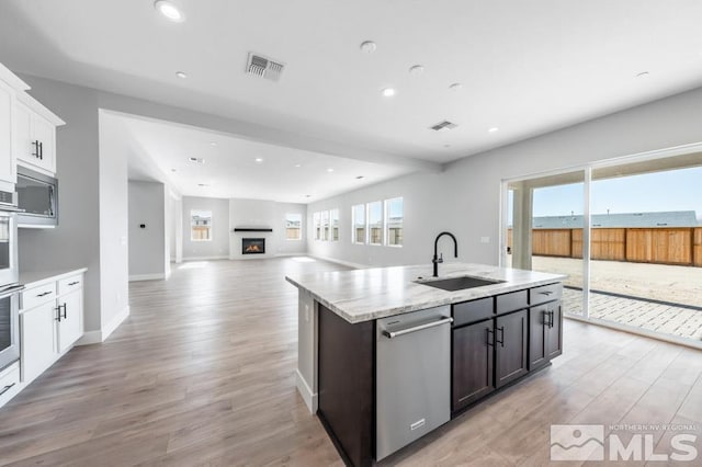 kitchen with dark brown cabinets, sink, dishwasher, light hardwood / wood-style floors, and white cabinetry