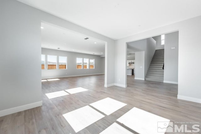 unfurnished living room featuring light hardwood / wood-style flooring