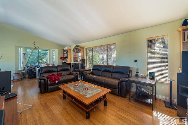 living room with a healthy amount of sunlight and vaulted ceiling