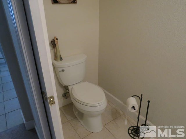 bathroom with tile patterned flooring and toilet