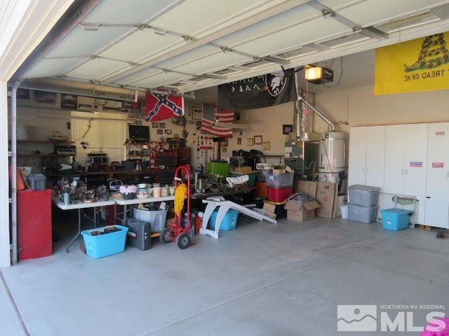 garage featuring water heater, a garage door opener, and a workshop area