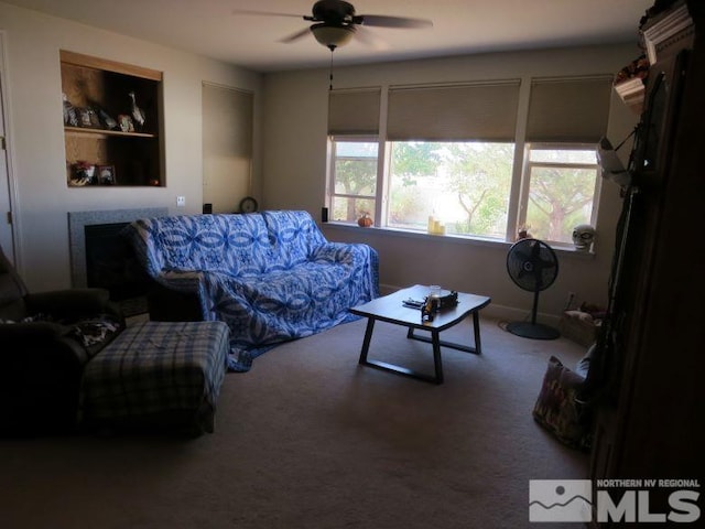 carpeted living room featuring ceiling fan