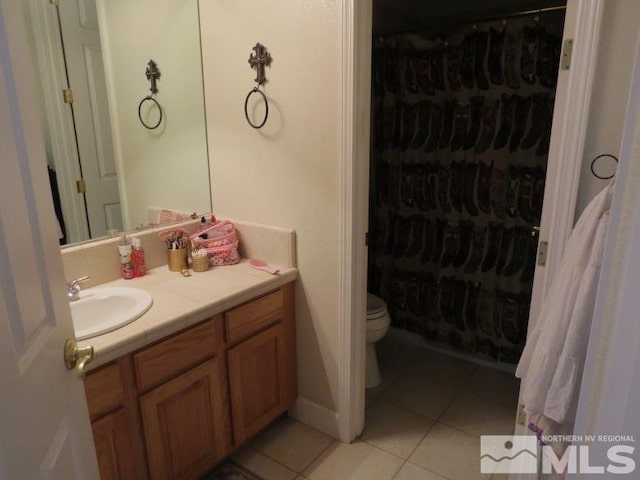 bathroom with vanity, toilet, and tile patterned floors