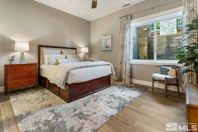 bedroom with ceiling fan and light hardwood / wood-style floors