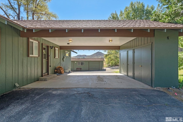 garage featuring a carport and wood walls