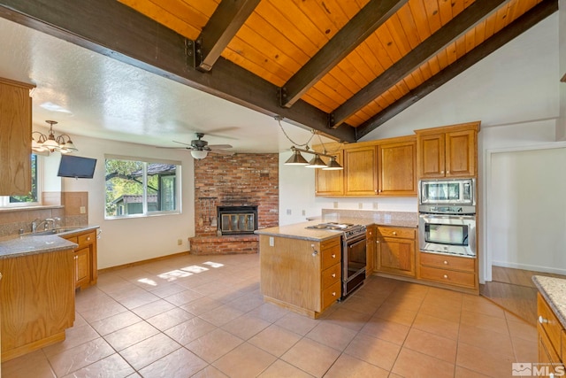 kitchen featuring ceiling fan, decorative light fixtures, stainless steel appliances, and a fireplace