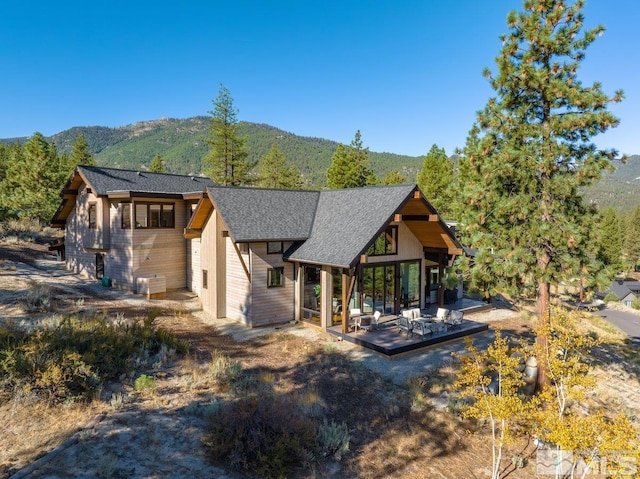 exterior space featuring a mountain view and a patio area