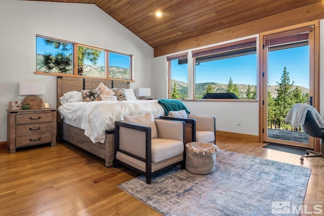 bedroom featuring wooden ceiling, light hardwood / wood-style floors, lofted ceiling, and access to exterior