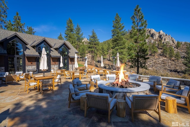 view of patio featuring a mountain view and a fire pit