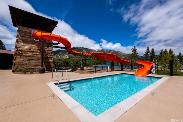 view of swimming pool with a water slide