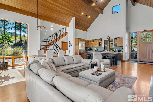 living room with high vaulted ceiling, wood ceiling, beamed ceiling, and light hardwood / wood-style flooring