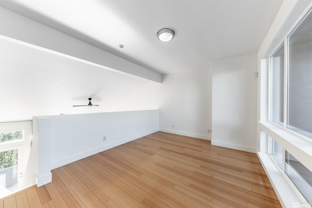 unfurnished room with ceiling fan and light wood-type flooring