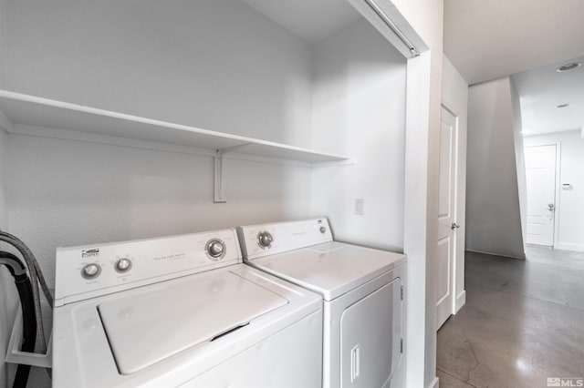 laundry room with washing machine and clothes dryer