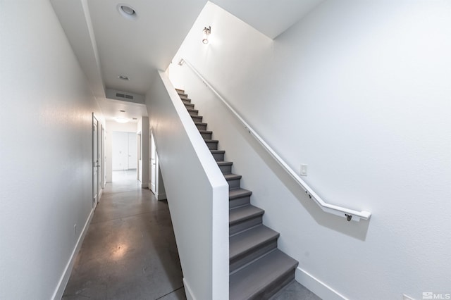 stairway featuring concrete floors