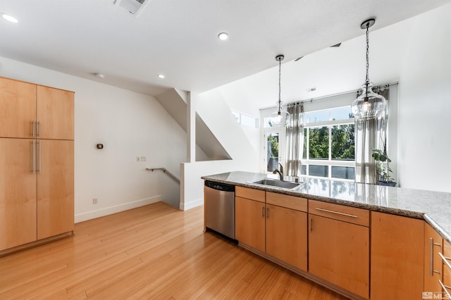 kitchen with light wood-type flooring, sink, stainless steel dishwasher, decorative light fixtures, and light stone countertops