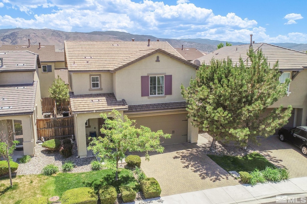 view of front of property with a garage and a mountain view