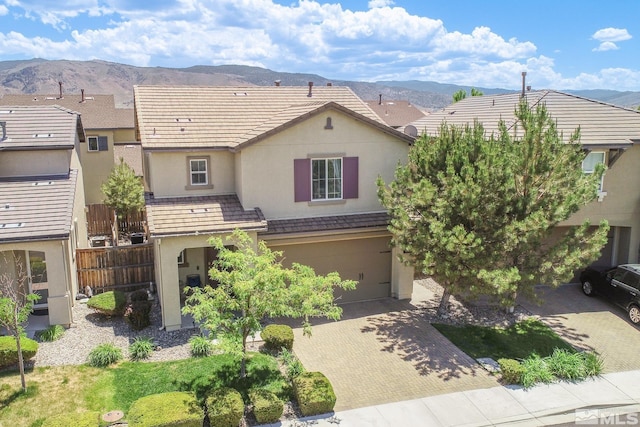 view of front of property with a garage and a mountain view