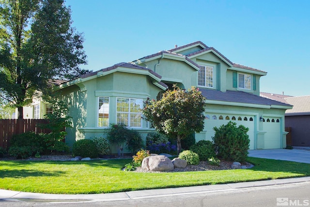 view of front of home featuring a front lawn and a garage