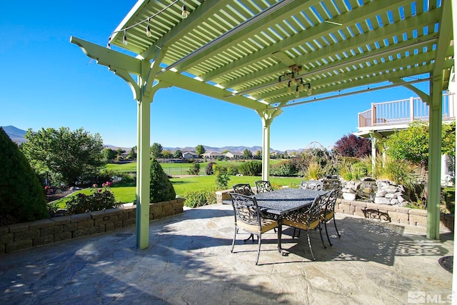 view of patio / terrace with a mountain view and a pergola