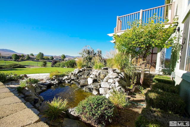 view of yard featuring a balcony and a mountain view