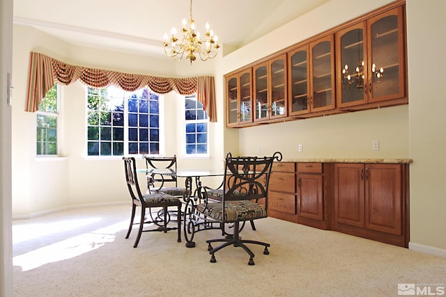 dining room with light carpet, an inviting chandelier, and lofted ceiling