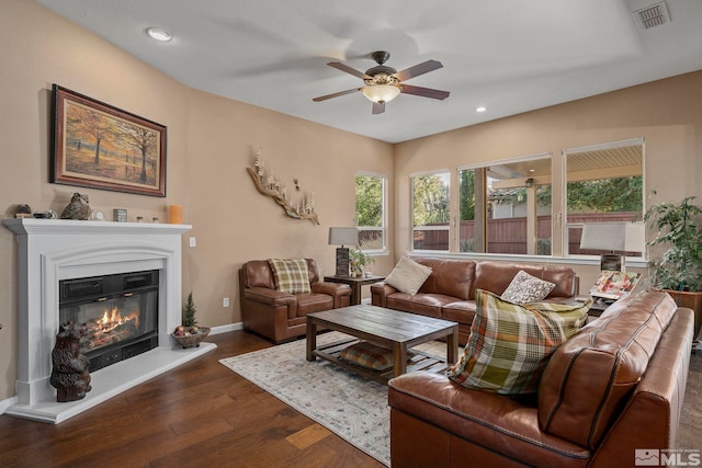 living room with ceiling fan and dark hardwood / wood-style floors