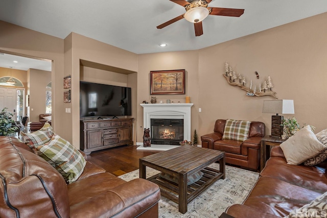 living room with ceiling fan and hardwood / wood-style flooring