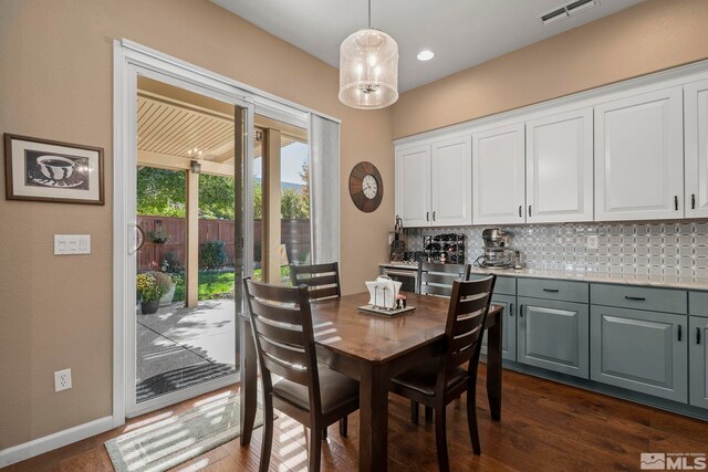 dining room with dark hardwood / wood-style floors