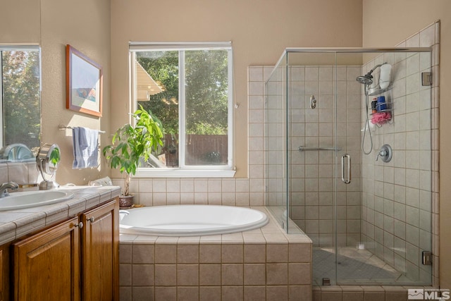 bathroom featuring vanity and separate shower and tub