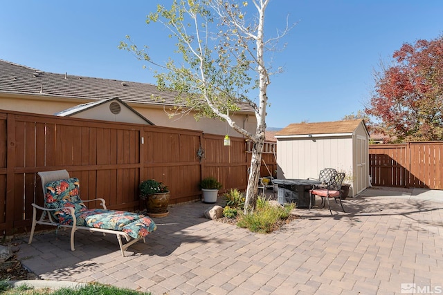 view of patio featuring a storage shed