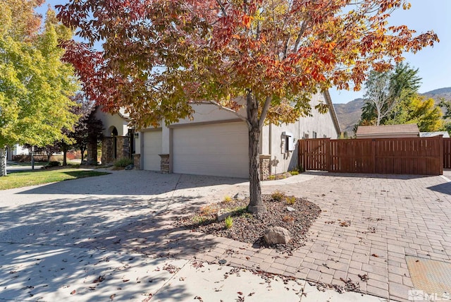 view of front of house with a mountain view and a garage