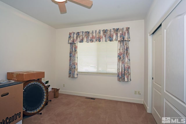 carpeted office with ceiling fan