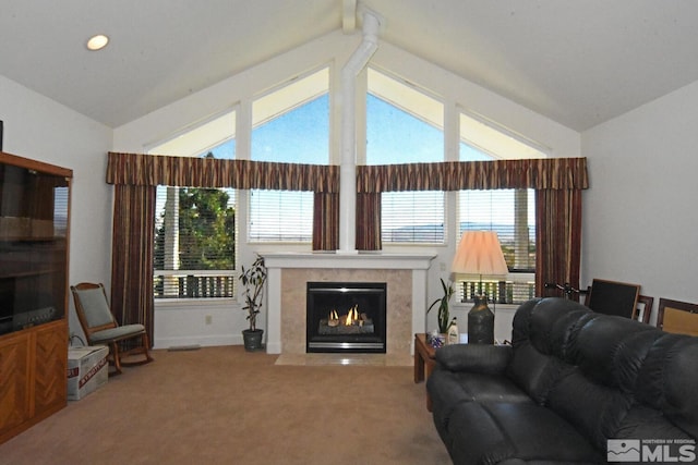 carpeted living room featuring beam ceiling, plenty of natural light, a premium fireplace, and high vaulted ceiling