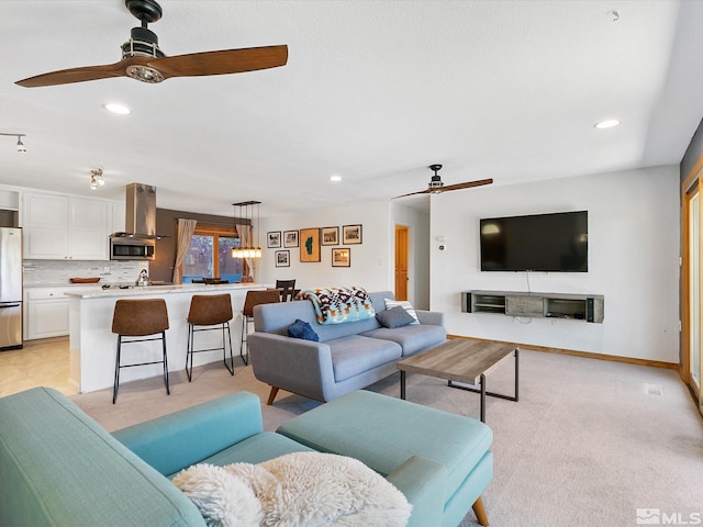 living room with ceiling fan and light colored carpet