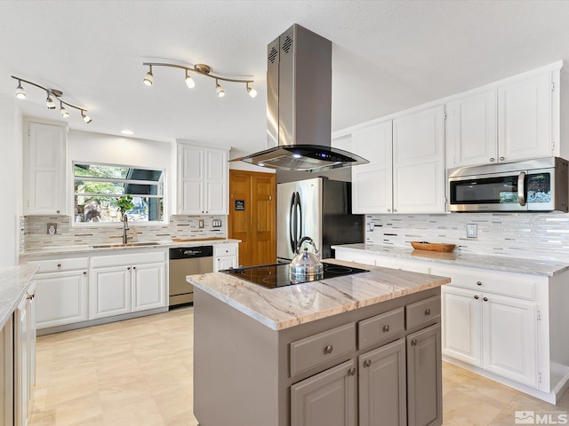 kitchen with island range hood, a center island, stainless steel appliances, and white cabinets