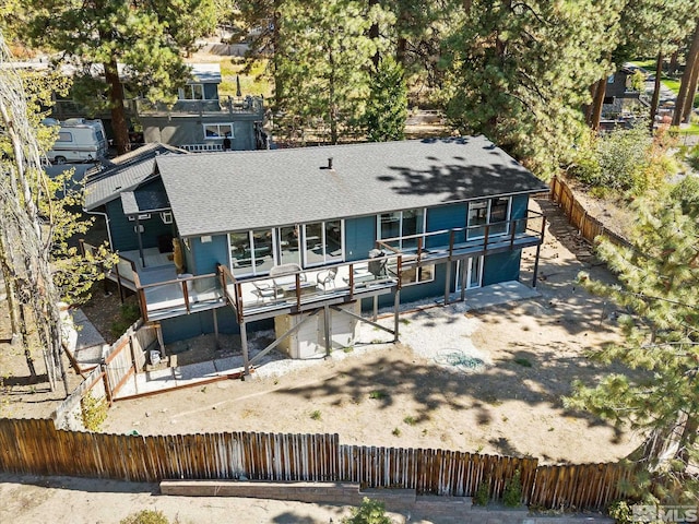 back of property with a wooden deck